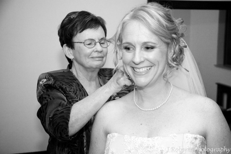 Mother putting necklace on bride - wedding photography sydney